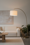 Modern arc floor lamp with brushed gold stand in contemporary living room